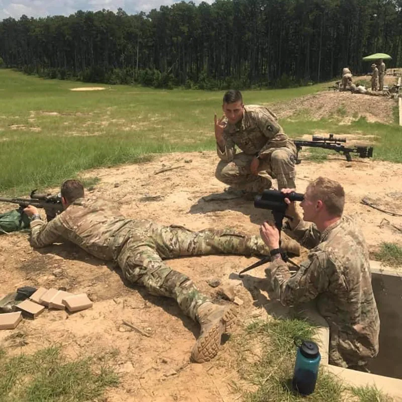 A group of military people holding guns in the fields